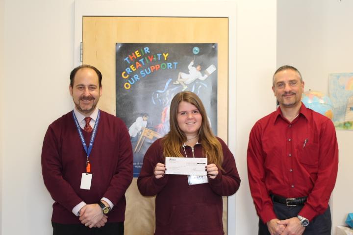Accepting the check are Dr. Rosen and eighth grader Emily Stone from Chris Markou of Alliance Energy