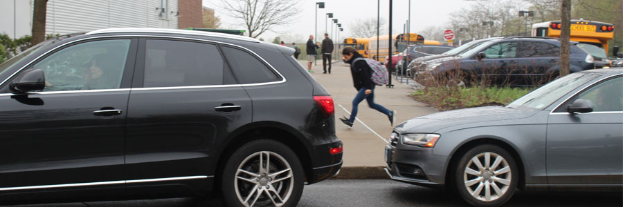 STRIKE AVERTED: A student rushes from her car to the school as busses arrive on time at Bedford.