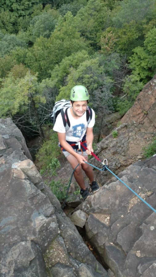 Above, an 8th grader repelling down a rock face in Kent, Connecticut.