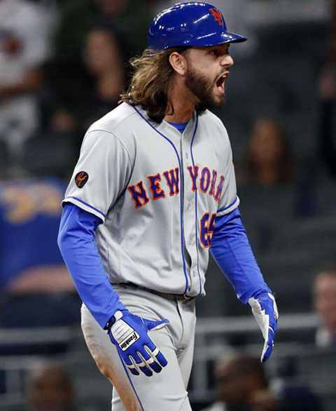 Robert Gsellman reacts to scoring the game-winning run against the Braves.