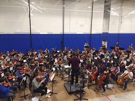 Sean O’Loughlin leading the orchestra in a piece written specifically for them. 