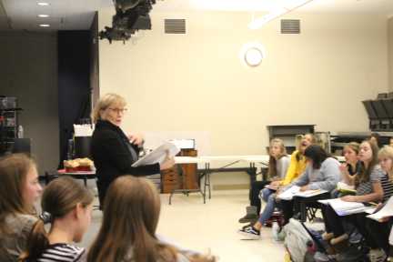 Mrs. Karen McCormick making the staff laugh while going over the script with cast of Into the Woods.