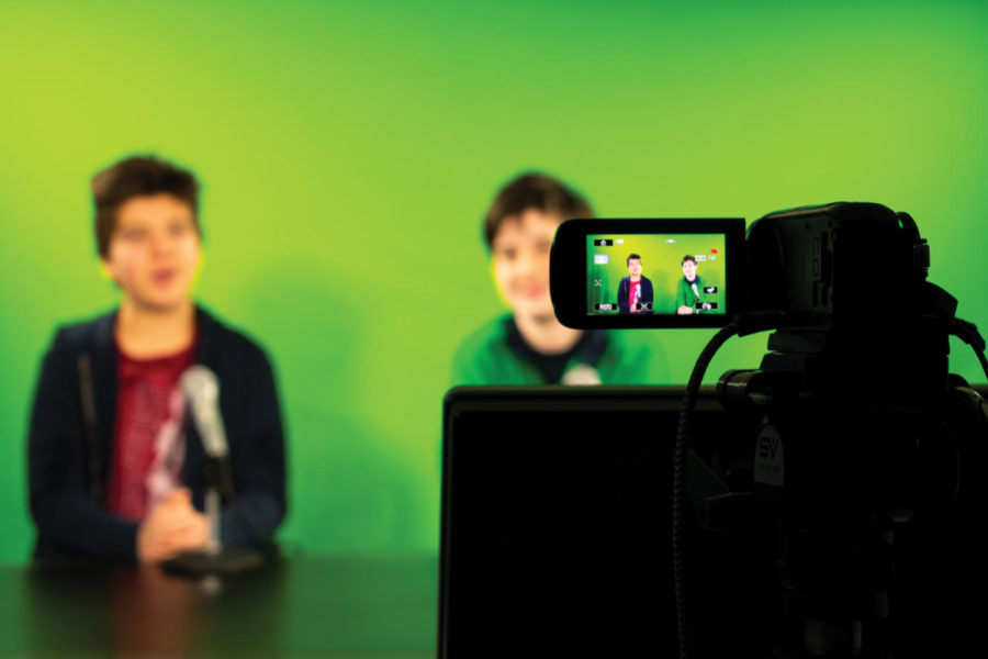  BCTV Hosts Cooper Sadler and Curtis Sullivan in front of the green screen airing a new episode of BCTV.