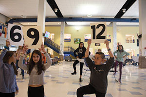 Sixth graders practicing “Three is a Magic Number” in the cafeteria. 