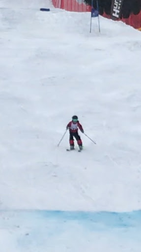 A 6th grader Skiing a challenging bump run.