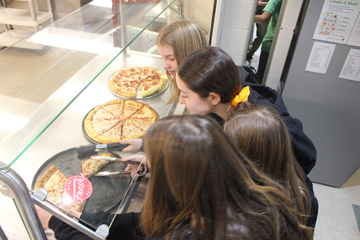 7th graders select their slices of pizza. Pizza was off the menu for six weeks due to a national ingredient shortage and pizza dough mix that contained sesame and eggs.