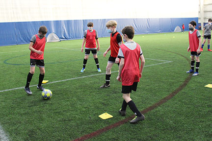 Inter CT soccer players following the mask-wearing mandate while doing a drill