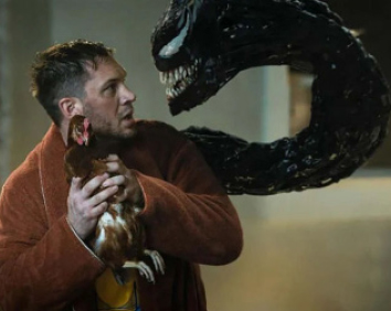 Eddie Brock holding chicken as venom comes out of his back.