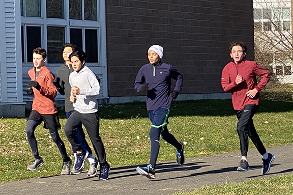 Sam Rondon, in blue, and other ninth-grade runners could have benefited from the practice a middle school running club would provide.