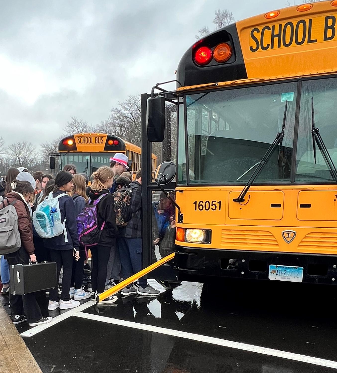 Students crowd to get onto a combined bus